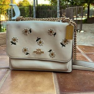Coach purse multi pocket chain strap with leather and embroidered design.